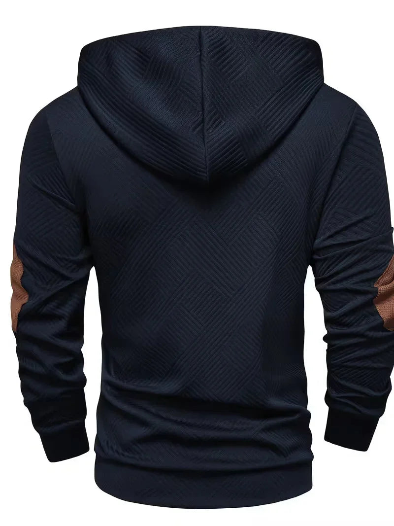 Mannelijk model wandelt buiten, draagt de Jesper gestructureerde hoodie en geniet van het comfort en de warmte.