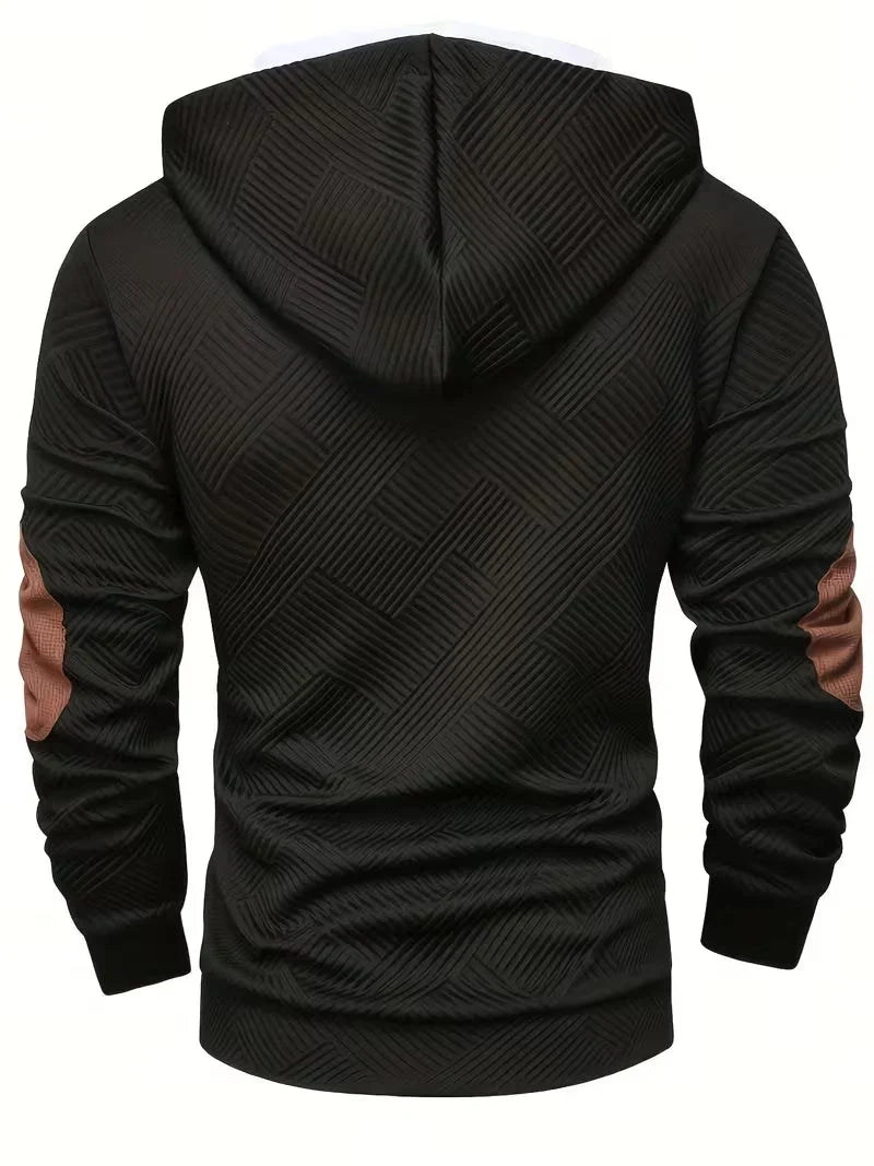 Een opgevouwen Jesper hoodie in een neutrale kleur, liggend op een houten oppervlak, benadrukt de stofkwaliteit.