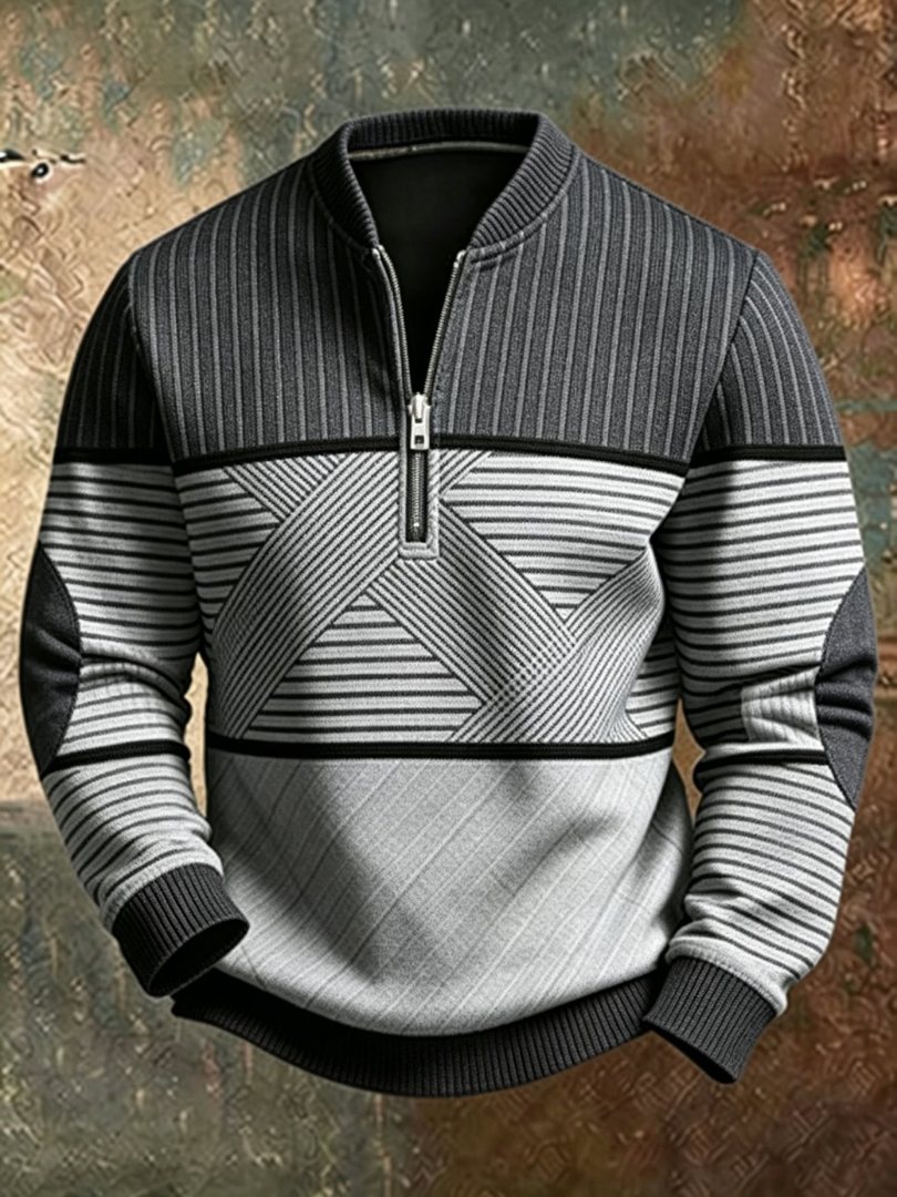 Detailopname van de half-zip sluiting en het unieke blokpatroon van de grijze heren sweater.