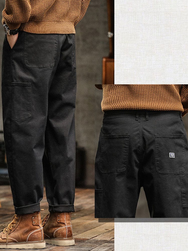 Close-up van de zoom van de zwarte broek, zowel opgerold als recht gedragen, voor stylinginspiratie.