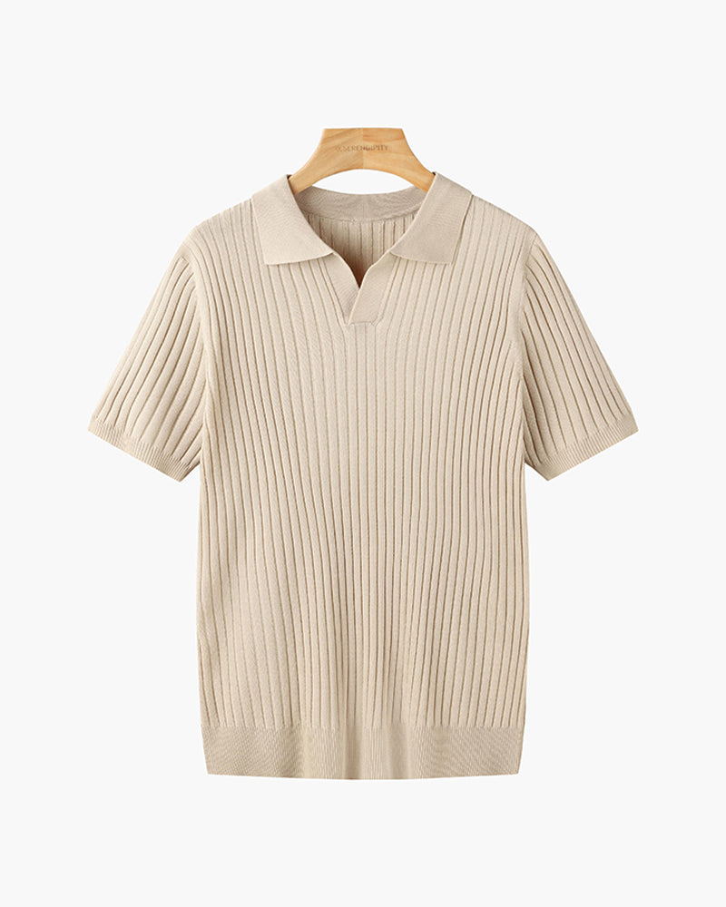Wit geribbeld V-hals poloshirt, schuin van bovenaf gefotografeerd, met lichte schaduwen die diepte geven.