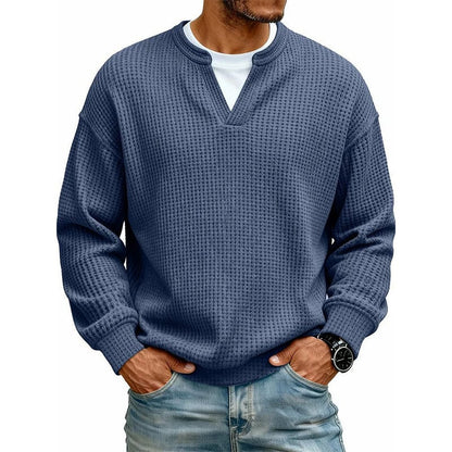 Model toont de witte Rinus sweater met verlaagde schoudernaad, casual gestyled met jeans, zijprofiel.