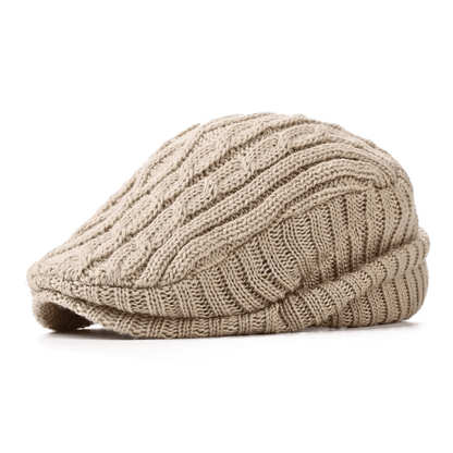 Detailopname van de gestructureerde kabelbrei van de beige Mick herenpet, met focus op de textuur en kwaliteit.
