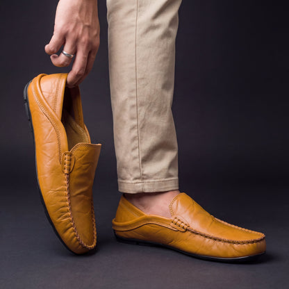 Bovenaanzicht van de beige Jorin leren pantoffels, met focus op de handgestikte details en de textuur van het leer.