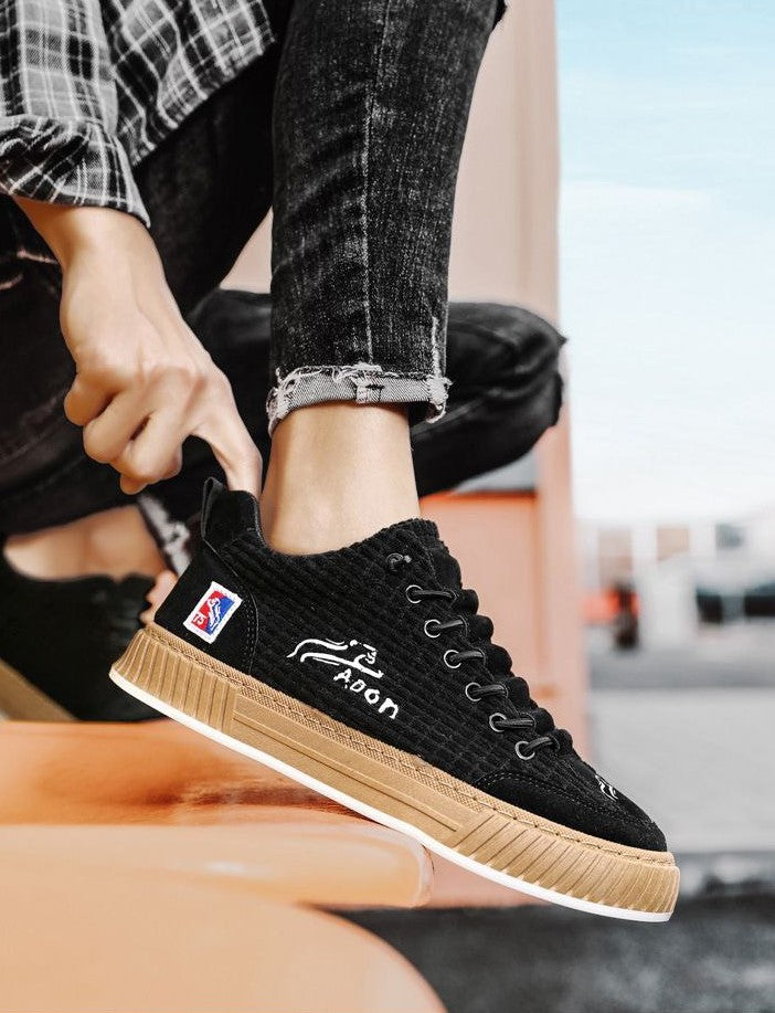 Een man draagt de zwarte Nils sneakers, gefotografeerd in een dynamische loopbeweging