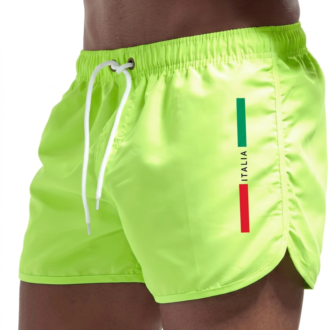 Een model draagt de Otis zwemshort in wit, wat de onbeperkte bewegingsvrijheid tijdens zomerse activiteiten illustreert.