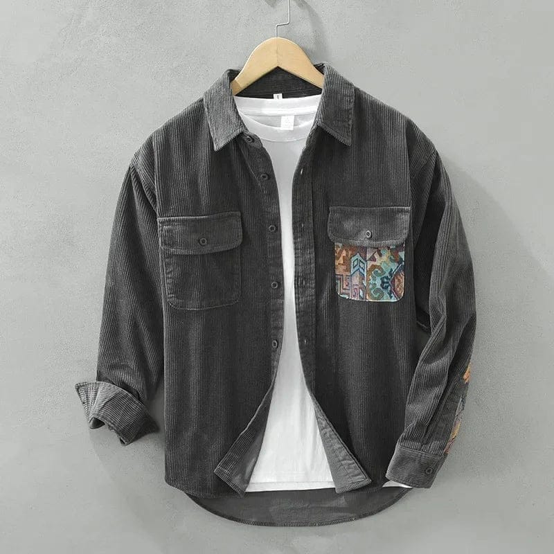 Detailopname van de geweven artisanale zak op het bruine corduroy overshirt, wat de unieke afwerking toont.