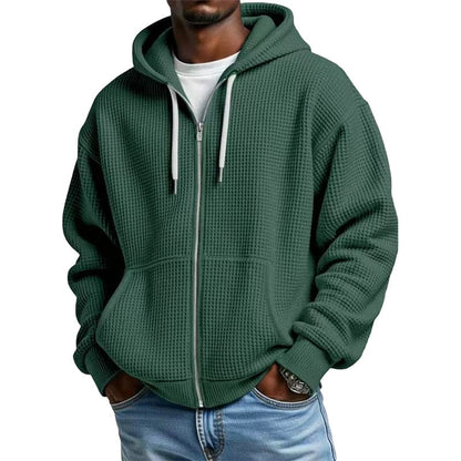 De Gerrit hoodie in paars, netjes opgevouwen op een houten oppervlak, toont de hoogwaardige textuur.