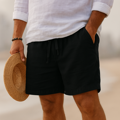 Willem katoen-linnen shorts in kaki, gedragen door een man in een ontspannen zomerse setting, zittend.